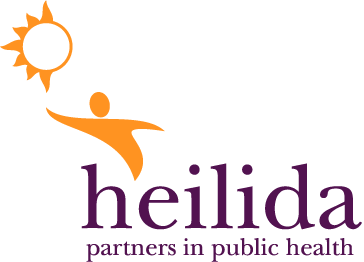 The final logo: Heilida written in lowercase, with a figure coming of the gap between the 'H' and the 'E'. The figure supports a stylised version of the IHSD sun
